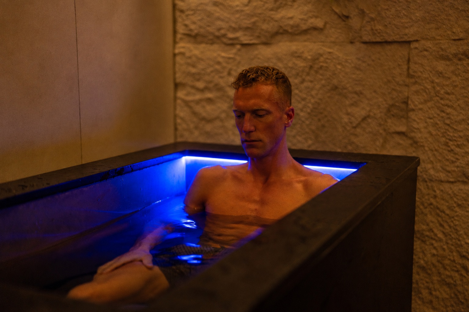 Kieran in a cold plunge tub, alert and composed